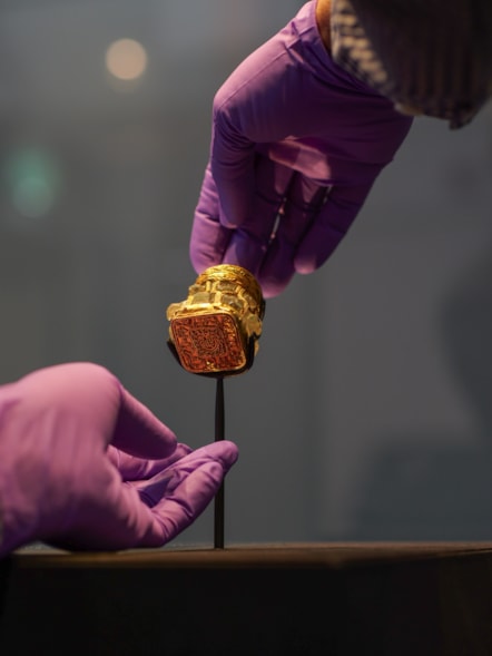Curator Craig Angus from National Museums Scotland puts finising touches to the installation of the Rock Crystal Jar from the Galloway Hoard at Kirkcudbright Galleries, image credit Andy Jardine