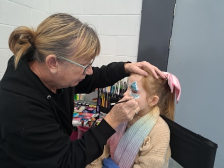 7 year old Aleina-Rae has her face painted by Janet Case of Cases Faces