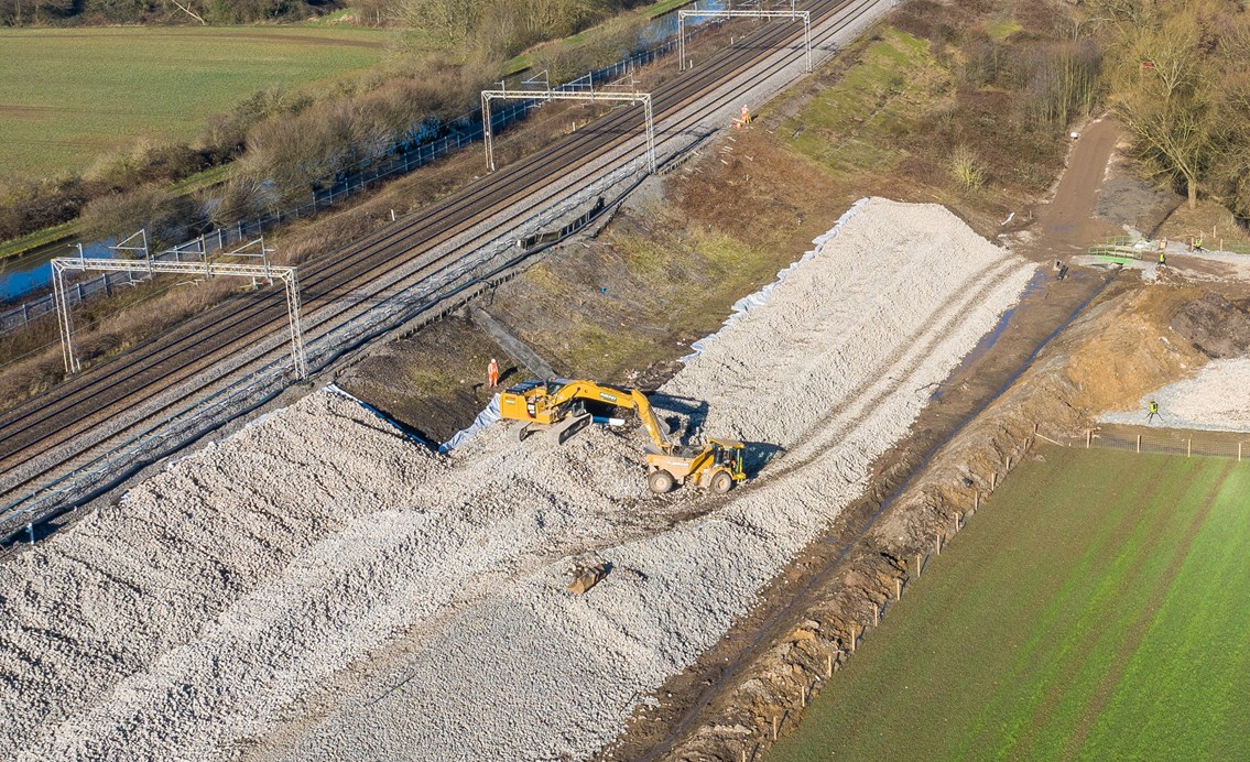 Aerial shot showing digger strengthening Hopsford Hall embankment Spring 2021