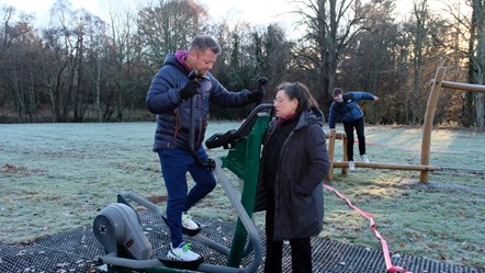 Ann Rossiter who was instrumental in getting the Forres Outdoor Gym in place is showing Forres academy principal teacher of Physical Education and Leadership Scott Fraser how to use a machine.