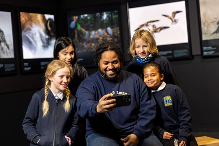 Wildlife cameraman and presenter Hamza Yassin met children from Edinburgh's Bun Sgoil Taobh Na Pairce (Parkside Primary School) at the opening of the new exhibition, Wildlife Photographer of the Year, which opens on Saturday 20 January at the National Museum of Scotland. Image © Duncan McGlynn-5