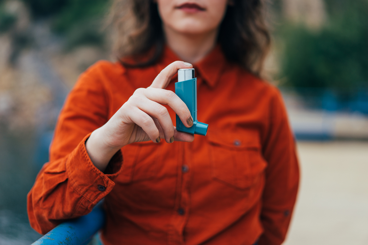 Person holding an asthma inhaler. Image from Getty Images.