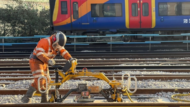 COMPLETED: Full service resumes between London Waterloo and Clapham Junction after upgrades to South Western Railway network: Work at Queenstown Road with a SWR train passing