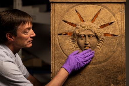 Curator Dr Fraser Hunter examines the Roman altars.Photo © Duncan McGlynn (3)