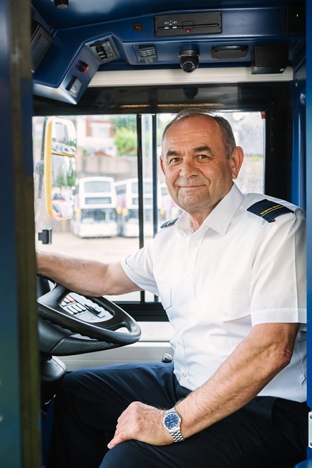 A bus driver behind the wheel of a bus in Brighton