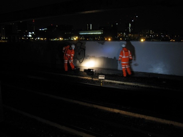 Network Rail volunteers at work: Network rail volunteers removing graffiti on approach to Birmingham City Centre