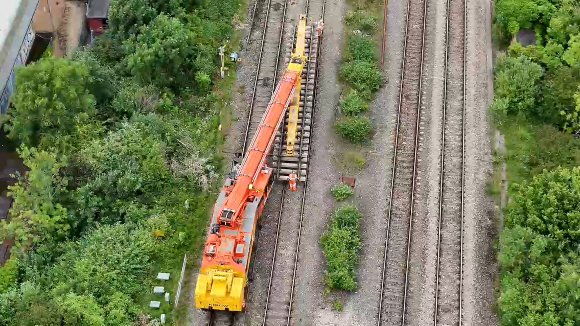 Trains running as normal after work completed between Bristol and South Wales: Kirow crane installing track panels at Filton