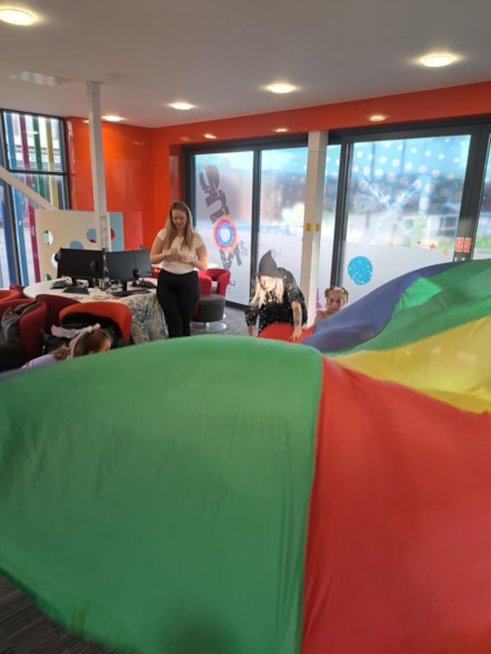 A parachute game at the Holiday Activities and Food (HAF) Club in Skelmersdale