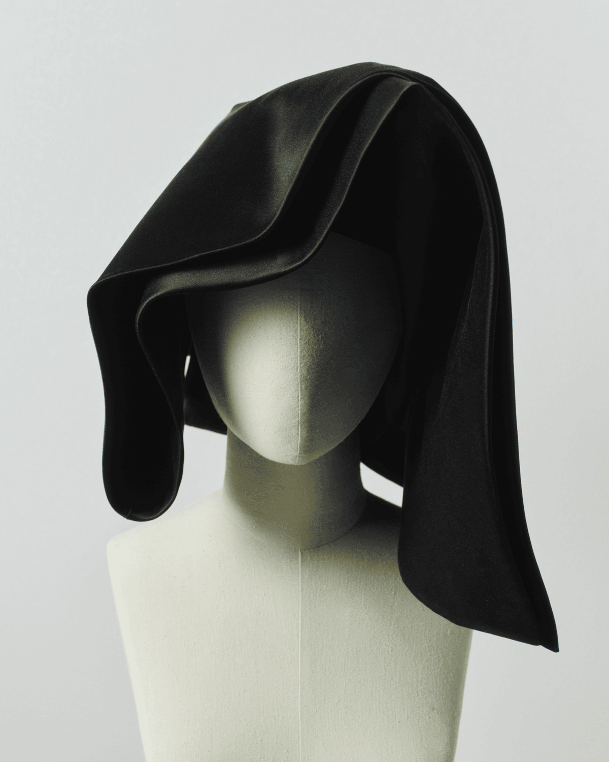 Image of a striking black cornette on a mannequin. 

Image Courtesy of JW Anderson.