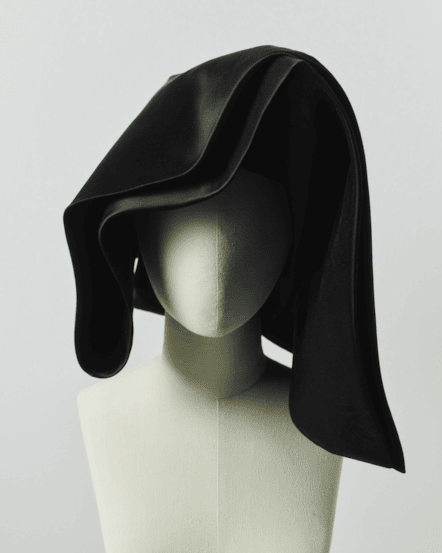 Image of a striking black cornette on a mannequin.