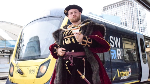 Fit for a king – Henry VIII takes South Western Railway train to Hampton Court Garden Festival: Henry with SWR Red Rose train at Waterloo