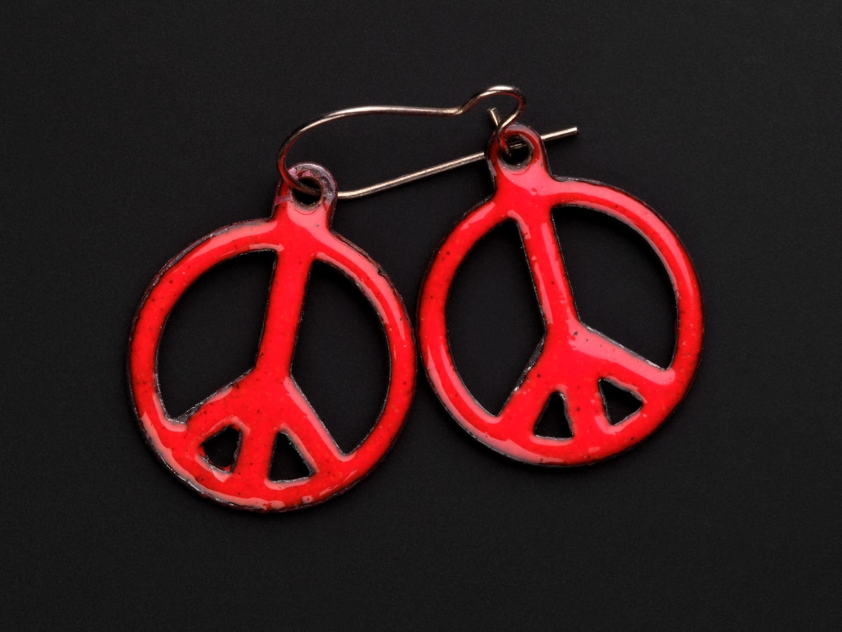 Pair of earrings in the form of red enamel CND emblem c. 1960s - 1990s Image © National Museums Scotland 