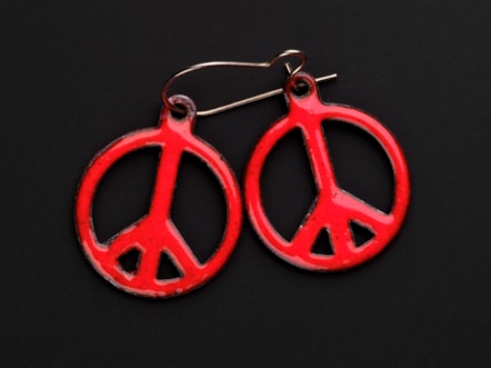 Pair of earrings in the form of red enamel CND emblem c. 1960s - 1990s Image © National Museums Scotland 