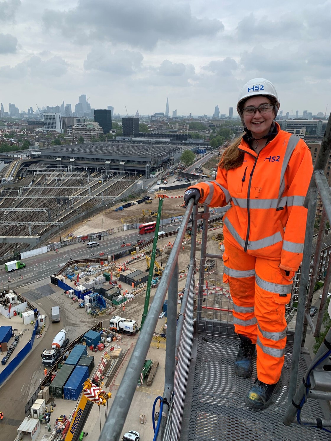 Hannah pictured standing next to the construction of HS2's new station at London Euston