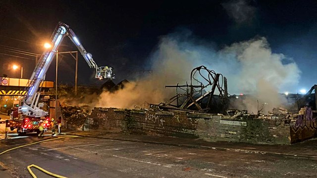 Railway reopens after major Wolverhampton warehouse fire: Wall after overnight demolition of fire damaged Wolverhampton warehouse