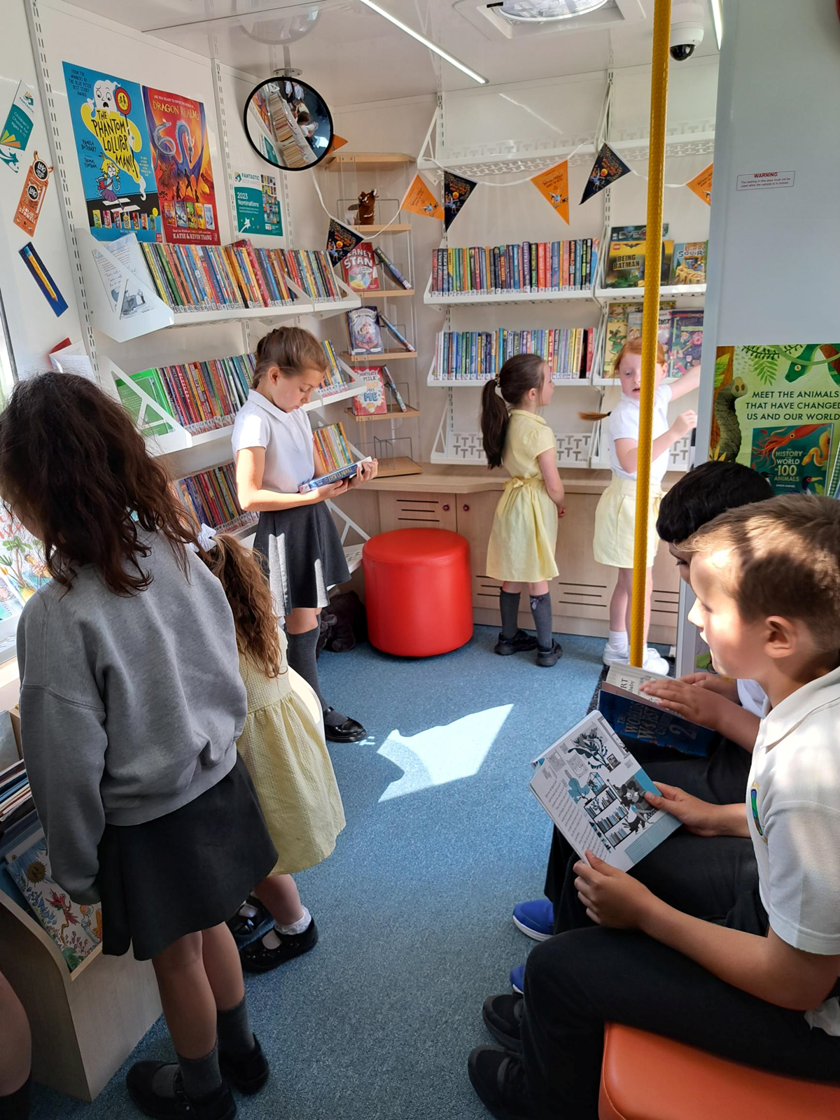 Pupils from Woodland Community Primary School in Skelmersdale enjoy the books in the school mobile bus which has come to visit.-2