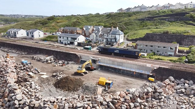 Engineering locomotive passing over new sea wall at Parton