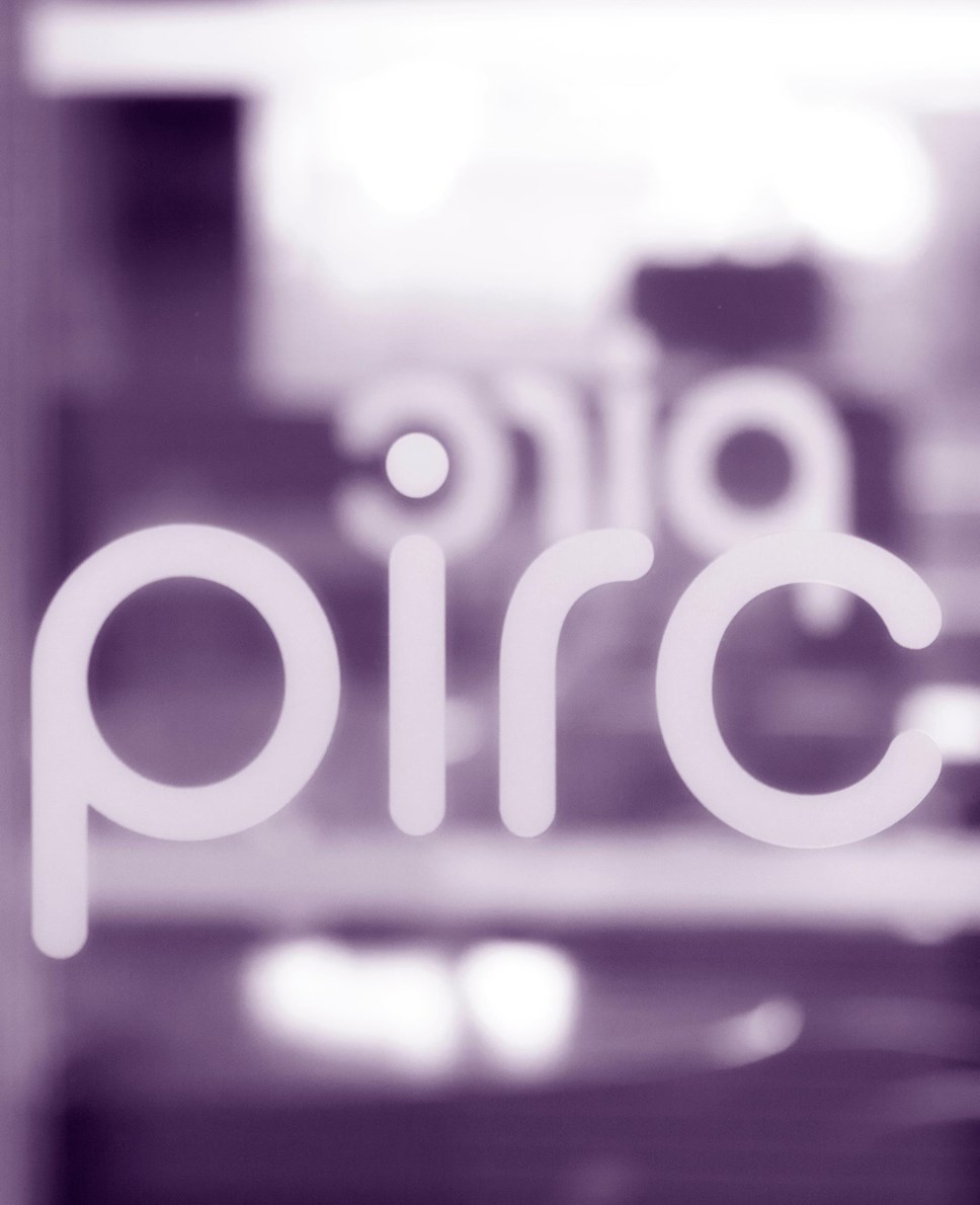 PIRC logo on glass purple wash