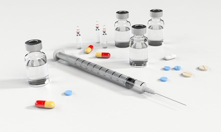 Image of syringe, pills and phials of insulin-like liquid.