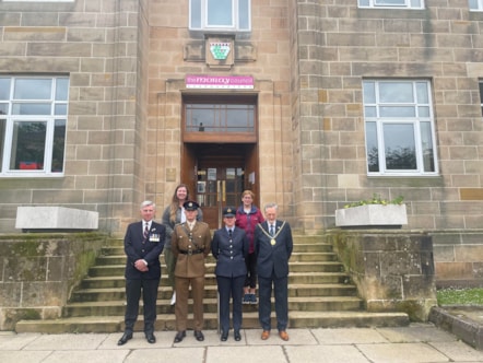 The council’s Service veteran – Cllr Donald Gatt (left) stands with the fellow councillor Cllr Amber Dunbar, Moray Council Leader Cllr Kathleen Robertson, Moray Council Civic Leader Cllr John Cowe, Fg Off Jessica Hunt of RAF Lossiemouth, and Lt Ethan Knight of 39 Engineer Regiment. to raise the Arme
