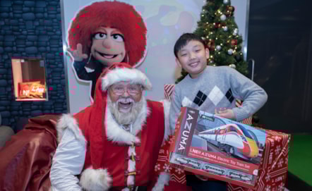 A child meets Father Christmas in the new LNER Family Lounge at Edinburgh Waverley