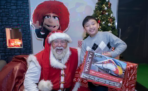 A child meets Father Christmas in the new LNER Family Lounge at Edinburgh Waverley