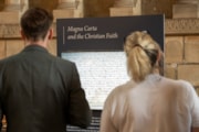 Visitors viewing part of the Magna Carta and the North exhibition in Durham Cathedral