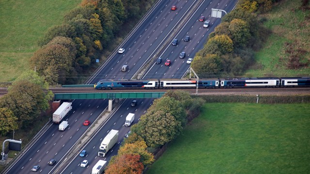 Public see rail as green but many still use cars - Network Rail survey finds: Avanti West Coast train passing over M6 - Credit Network Rail Air Operations-2
