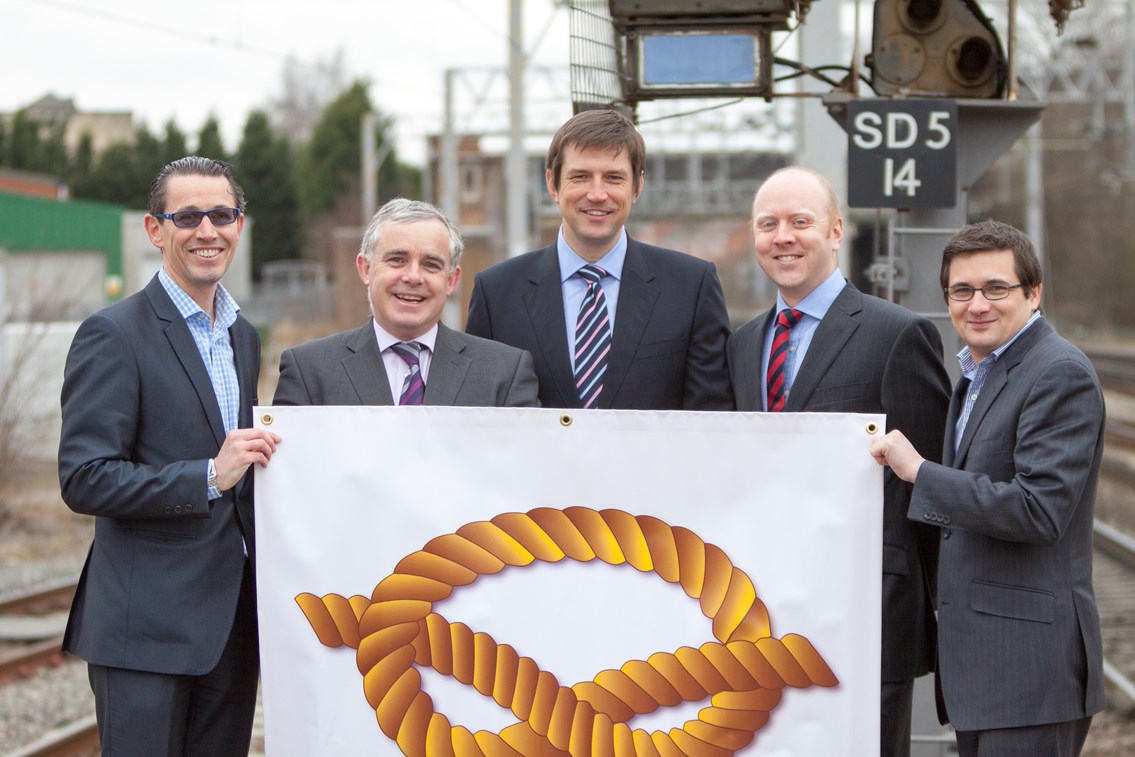 SAIP Alliance Leadership Team, picture 2: SAIP Alliance Manager Dominic Baldwin (far left) and the SAIP Alliance Leadership Team, left to right, Graeme Castle - Operations Leader for Laing O’Rourke Construction Ltd; Stuart Birch - Director of Major Projects for VolkerRail Ltd; Steve Higham - Managing Director, Rail Engineering Projects for Atkins; Rob Offord - Commercial & Finance Director (Central) for Network Rail Infrastructure Ltd, pictured with the 'Stafford knot' - the traditional symbol of Staffordshire and its county town, Stafford.