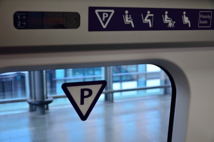 Train window with priority seating sign.
