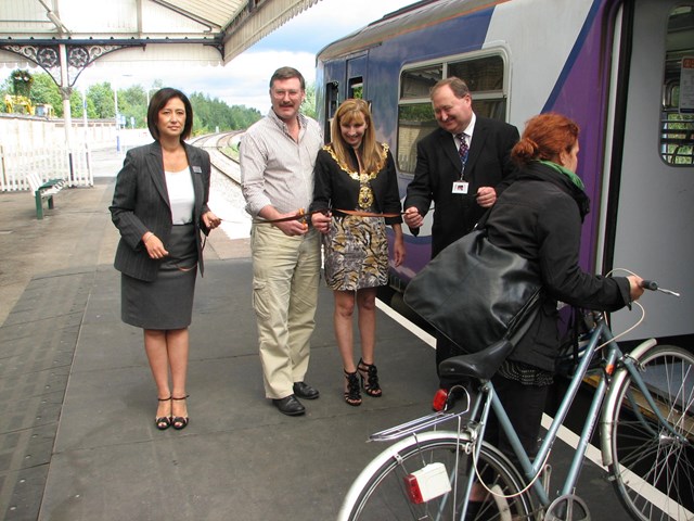 Northwich platform hump: A real passenger makes use of the hump moments before the official opening. l-r Natasha Wilding, Northern Rail head of stations - area west; Cllr Mike Jones, leader Cheshire West & Chester Council; Cllr Alison Gerrard, Northwich Town Mayor; Jon Kelly, Network Rail scheme sponsor.