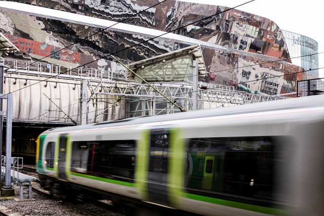 Birmingham New Street - London Midland Train arriving at station: Birmingham New Street 
railway station
train station
Grand Central
Shopping centre
train
platform
mirrored roof