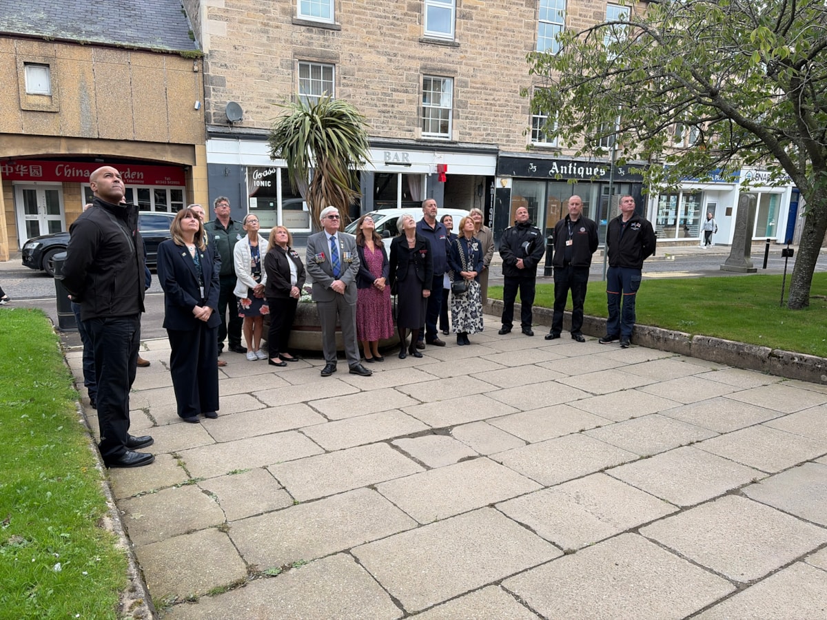 Members of Moray's emergency services join Moray Council officers and elected members to observe the Emergency Services Day flag being raised.