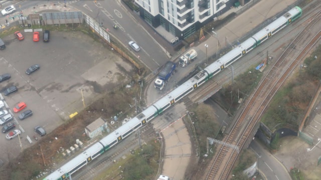 Aerial view of Mitre Bridge level crossing with train: Aerial view of Mitre Bridge level crossing with train