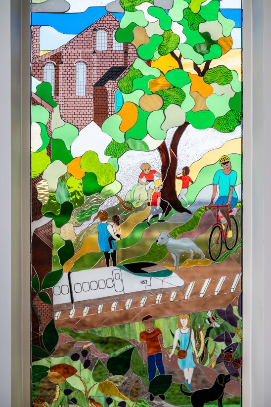 Stained glass window depicting the restored Burton Greenway, complete with a HS2 train
