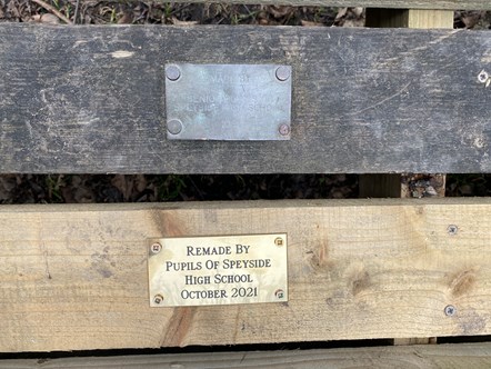 Original and new plaques commemorating Speyside High Pupils building benches