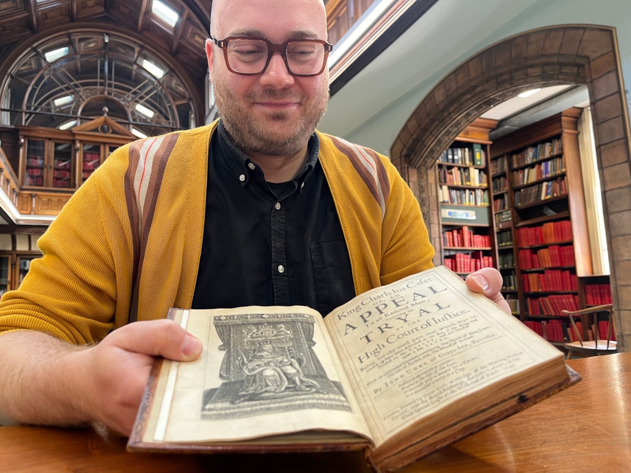 Battle books event: Librarian Josh Flint with the centuries-old court report from the infamous trial of King Charles I, which will be revealed later this month during a fascinating event in Leeds.
The remarkable book was created more than 360 years ago, and recounts in exhaustive detail the unprecedented week-long trial in 1649, which saw the King convicted of tyranny and treason and sentenced to death in the aftermath of the English Civil War.