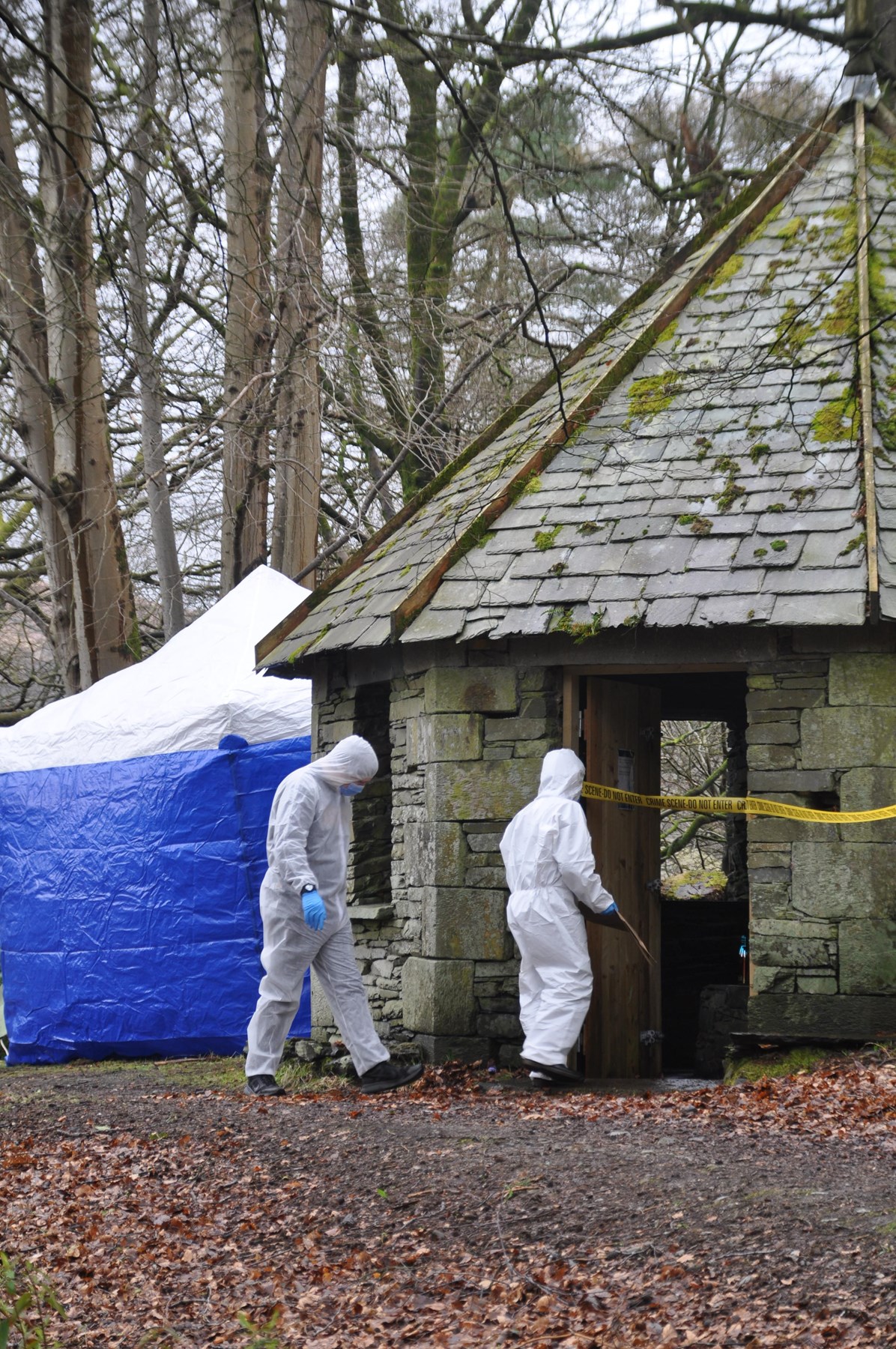 Student crime scene investigators attend a crime scene outdoors