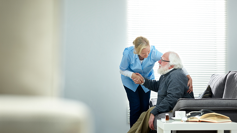 Milestone reached for social service workforce: Support worker with older man at home (image)