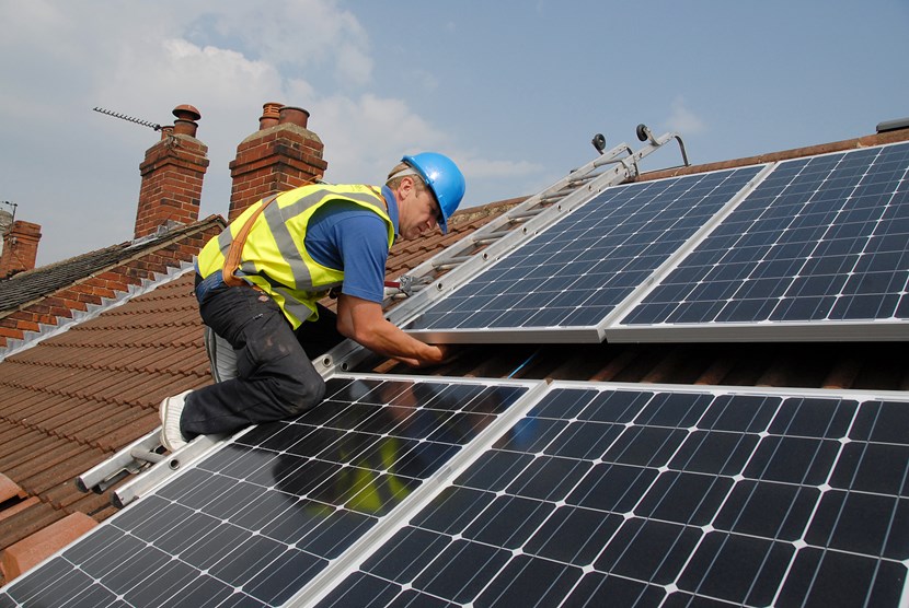 Free solar panel project steps up a gear: installingsolarpanels.jpg