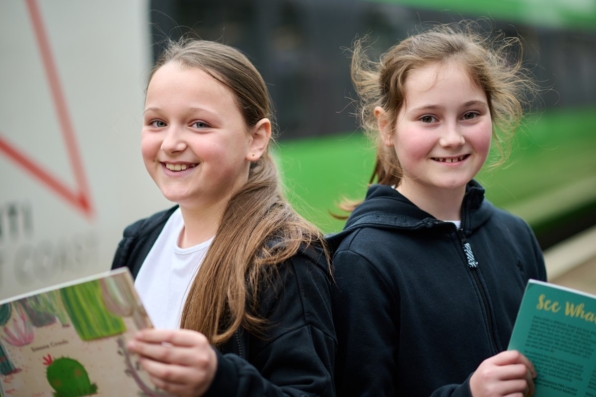 Jessica and Ella from Westfield Primary School in Runcorn with books donated by Avanti West Coast