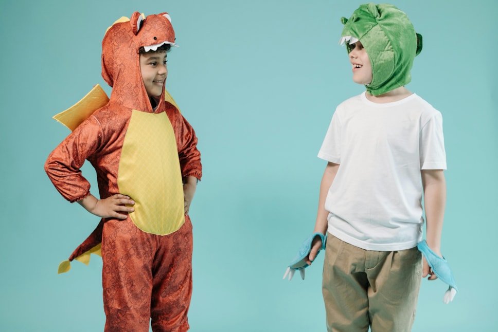 Two boys in dino costumes looking at each other credit Photo by Pavel Danily pexels