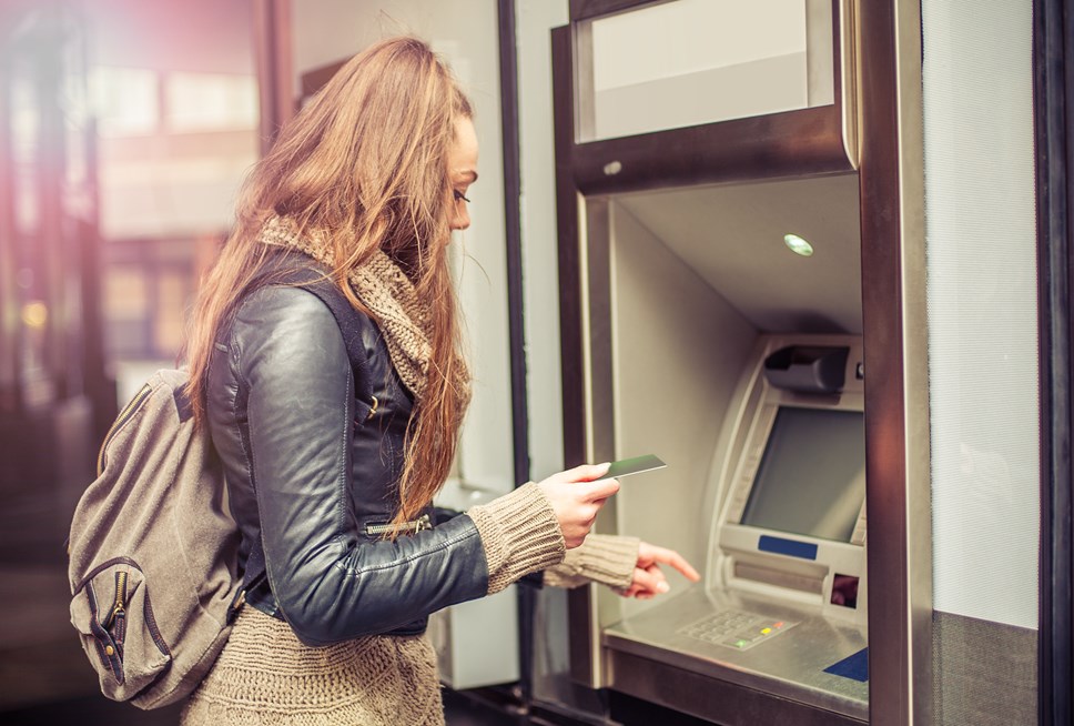 young person using cash machine