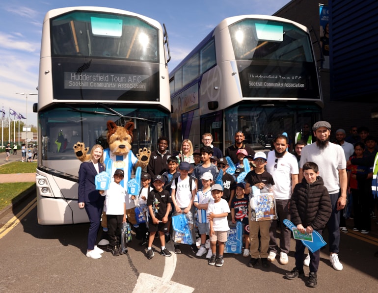First Bus and Huddersfield Town lift trophy for bringing families to first-time match