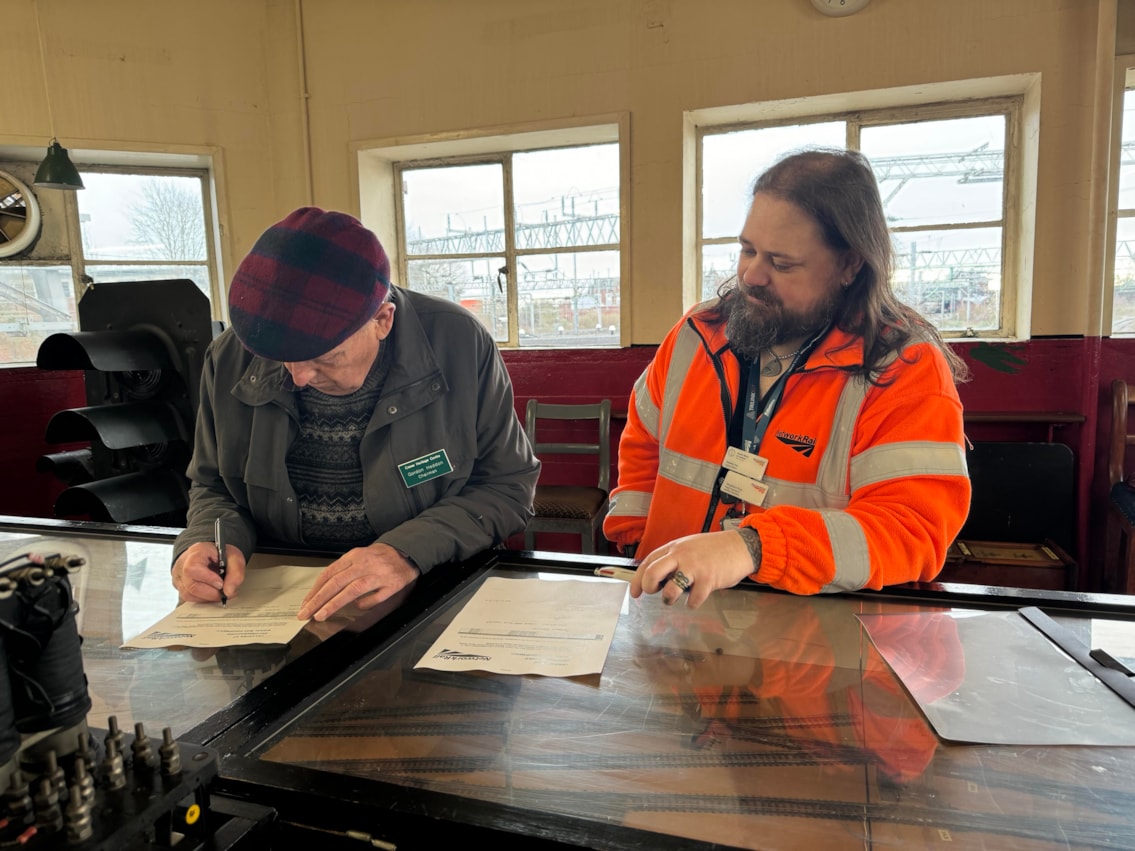 Signing over the plaque
