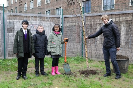 Cllr Champion and children at Hugh Myddelton Primary School plant a tree