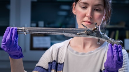Curator Ella Paul examines the pistol at National Museums Scotland. Image © Duncan McGlynn (2)