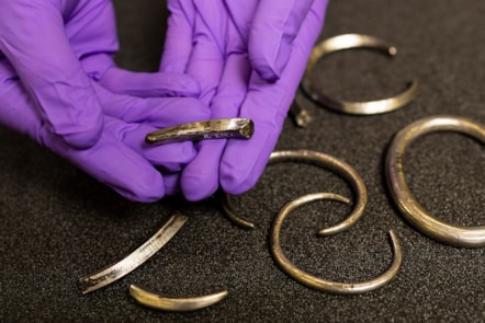 Assistant Curator Craig Angus with silver arm rings from the Burray Hoard. Photo © Duncan McGlynn (4)