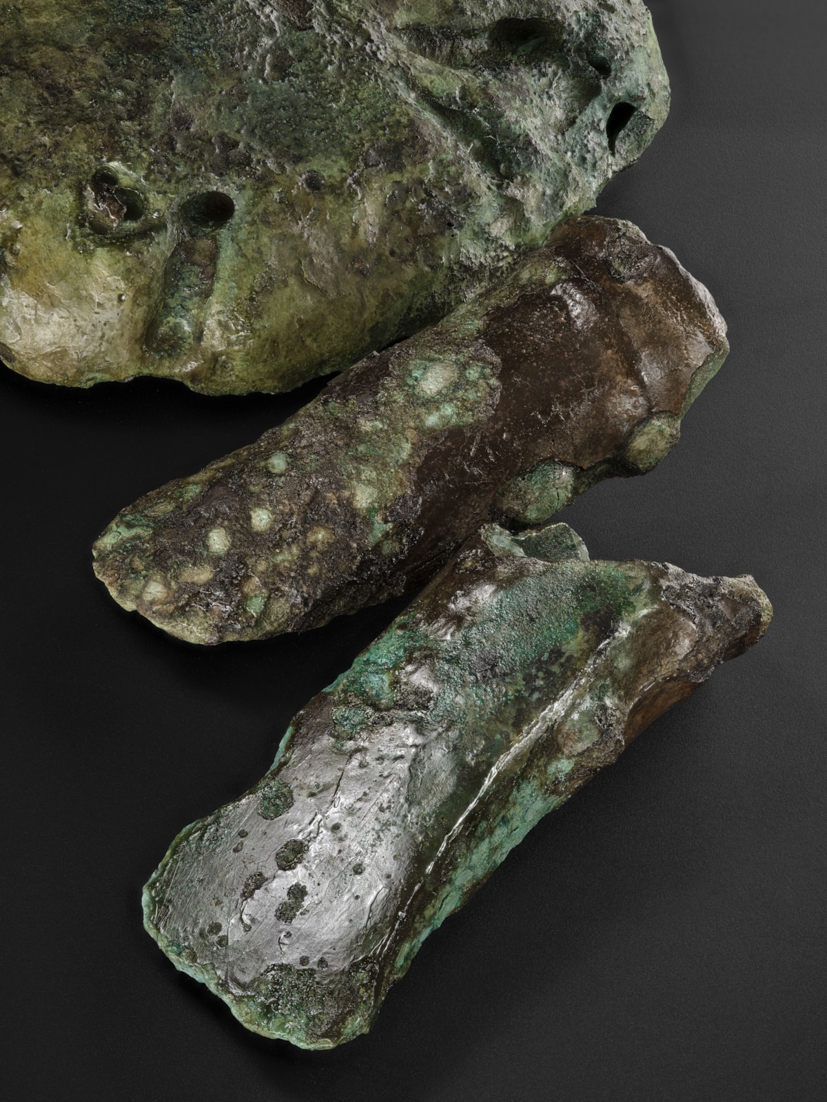 Bronze axehead, a copper ingot and mould fragments from the Blyth Hoard Image credit National Museums Scotland