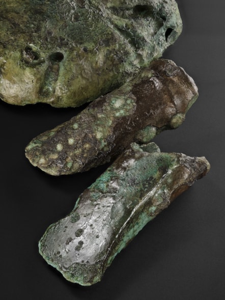 Bronze axehead, a copper ingot and mould fragments from the Blyth Hoard Image credit National Museums Scotland
